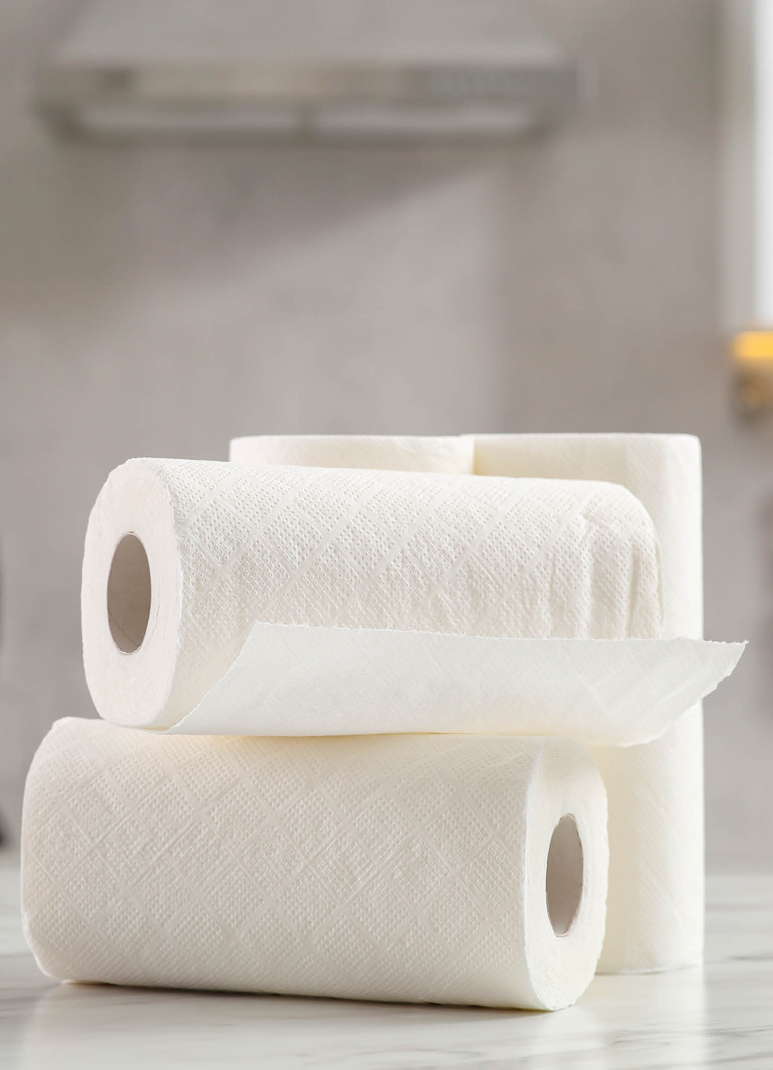 Rolls of paper towels on white marble table in kitchen